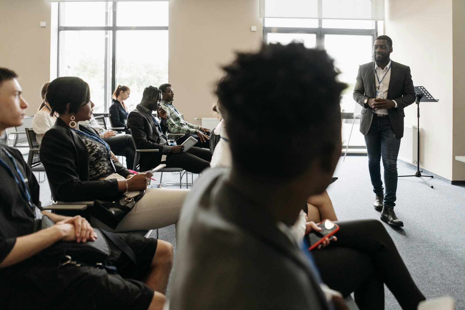 A Cognis trainer leading an in-person AI workshop for a seated group